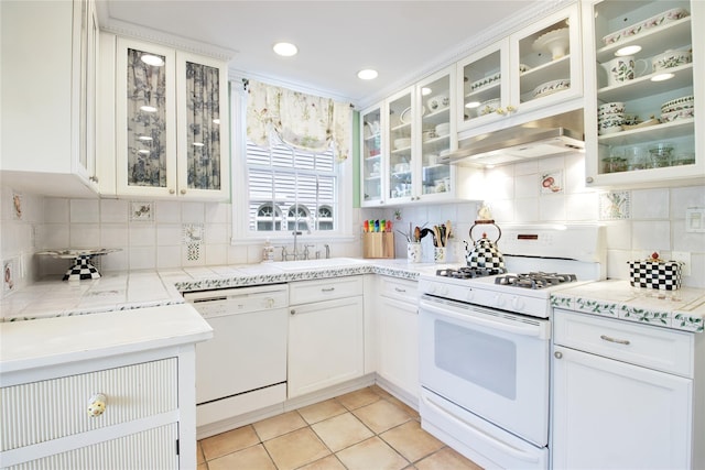 71 Hillcrest Ave, Manhasset, NY 11030 - kitchen with white appliances, wall chimney range hood, backsplash, white cabinets, and recessed lighting