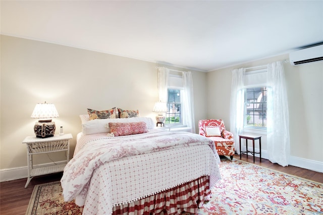 71 Hillcrest Ave, Manhasset, NY 11030 - bedroom with a wall unit AC, wood finished floors, and ornamental molding
