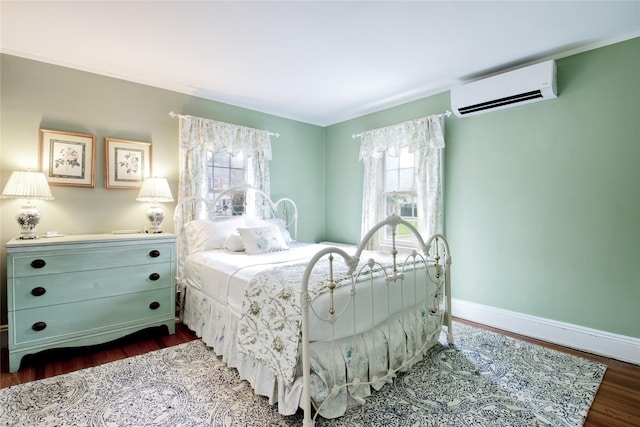 71 Hillcrest Ave, Manhasset, NY 11030 - bedroom featuring a wall unit AC and dark wood-style flooring