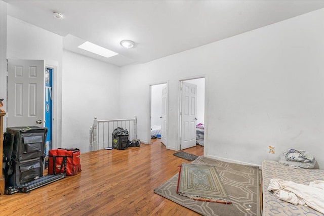 1047 Trinity Ave, Bronx, NY 10456 - misc room with a skylight, an upstairs landing, and wood finished floors
