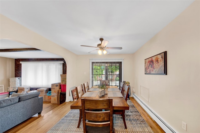 1455 Kennellworth Pl, Bronx, NY 10465 - dining room with a baseboard radiator, light wood-type flooring, ceiling fan, and arched walkways