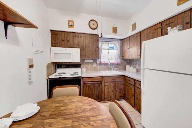 1455 Kennellworth Pl, Bronx, NY 10465 - kitchen featuring white appliances, tasteful backsplash, brown cabinets, light countertops, and light tile patterned flooring