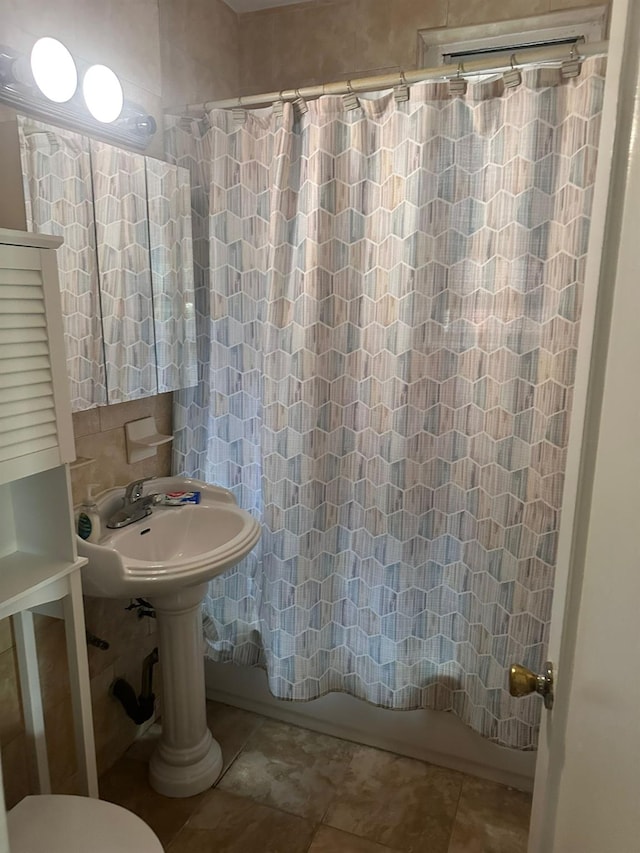 118-14 83rd Ave Unit 2E, Kew Gardens, NY 11415 - bathroom with shower / bathtub combination with curtain, tile patterned flooring, and tile walls