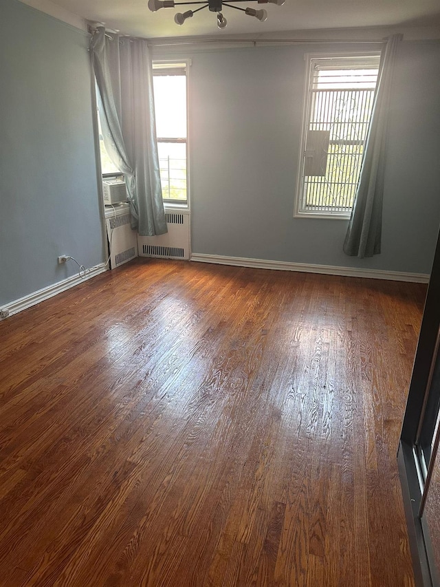118-14 83rd Ave Unit 2E, Kew Gardens, NY 11415 - unfurnished room with radiator heating unit and wood finished floors