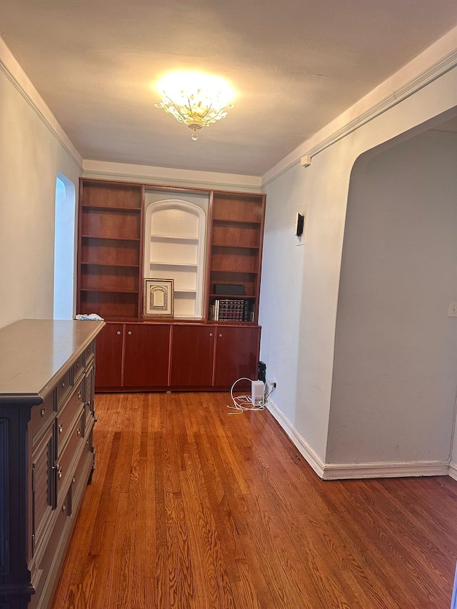 118-14 83rd Ave Unit 2E, Kew Gardens, NY 11415 - unfurnished dining area with arched walkways, wood finished floors, and ornamental molding