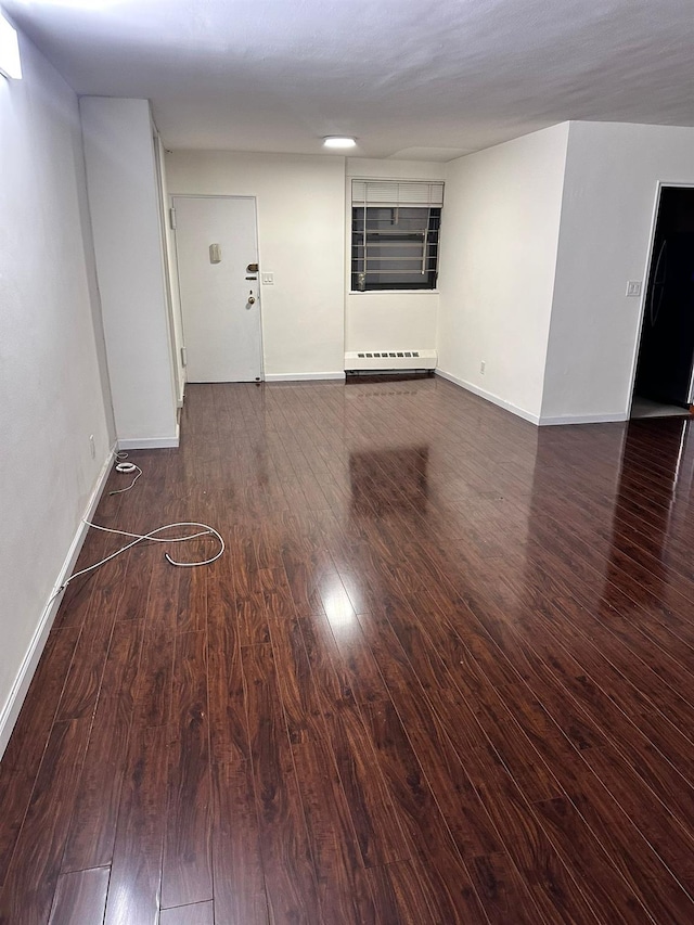 6145 98th St Unit 5J, Rego Park, NY 11374 - spare room featuring a baseboard heating unit and wood finished floors