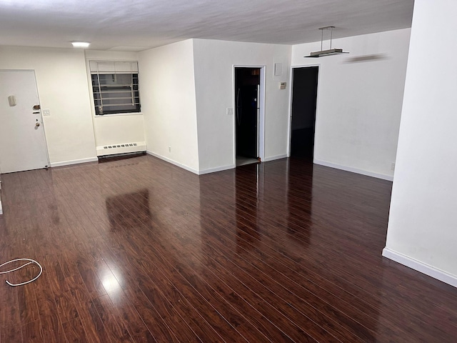 6145 98th St Unit 5J, Rego Park, NY 11374 - empty room with baseboard heating and wood finished floors
