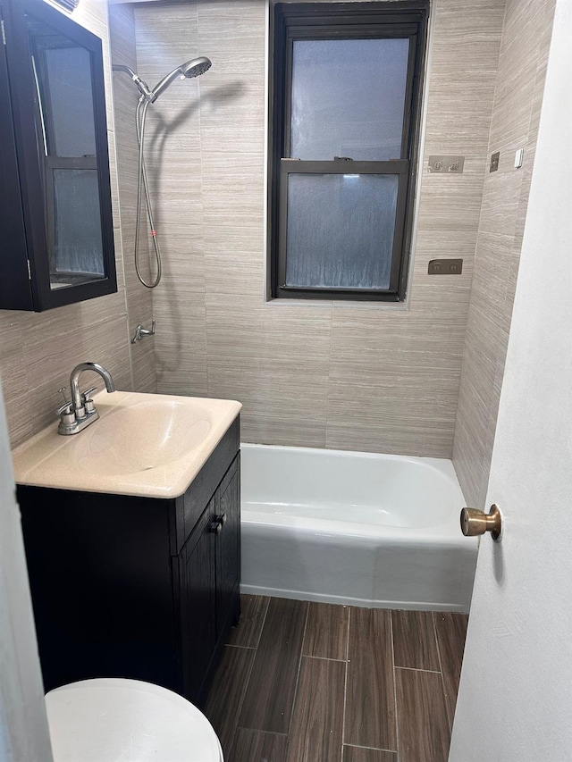 6145 98th St Unit 5J, Rego Park, NY 11374 - bathroom with vanity, tub / shower combination, tile walls, decorative backsplash, and wood tiled floors