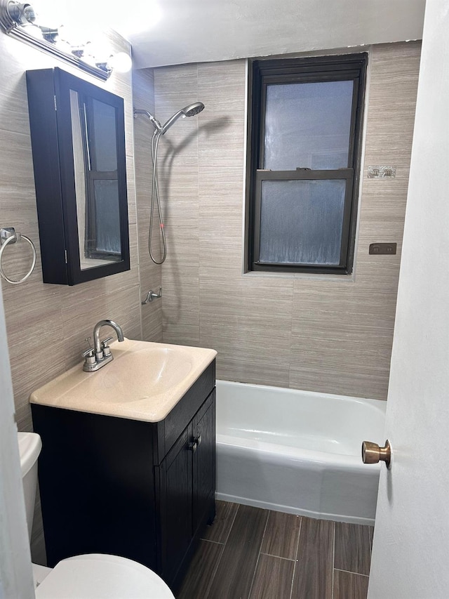 6145 98th St Unit 5J, Rego Park, NY 11374 - bathroom featuring tile walls, vanity, and  shower combination