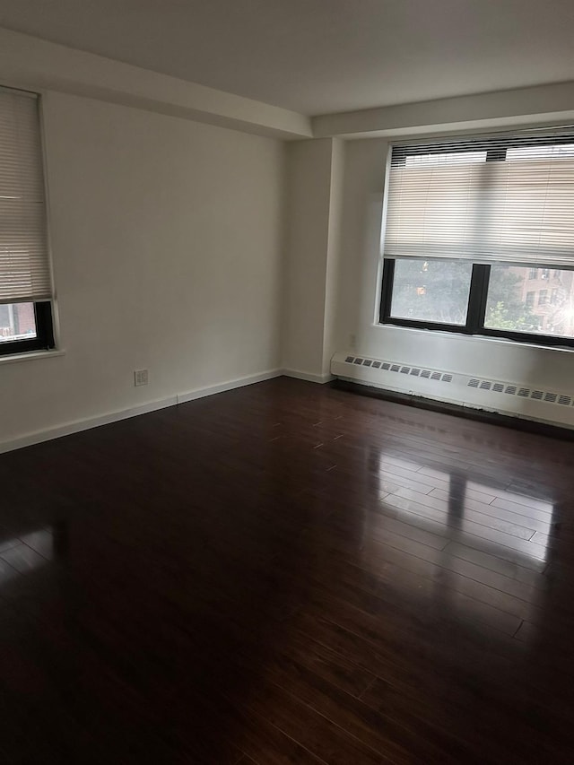 6145 98th St Unit 5J, Rego Park, NY 11374 - unfurnished room featuring a baseboard radiator and dark wood finished floors