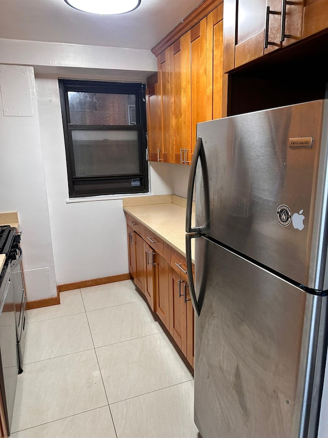 6145 98th St Unit 5J, Rego Park, NY 11374 - kitchen with freestanding refrigerator, brown cabinetry, and range