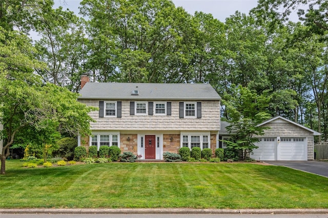 15 Shadetree Ln, Stony Brook, NY 11790 - colonial inspired home with stone siding, asphalt driveway, a front lawn, a chimney, and an attached garage