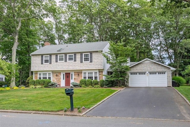 15 Shadetree Ln, Stony Brook, NY 11790 - colonial house featuring a garage, a chimney, a front yard, stone siding, and view of wooded area