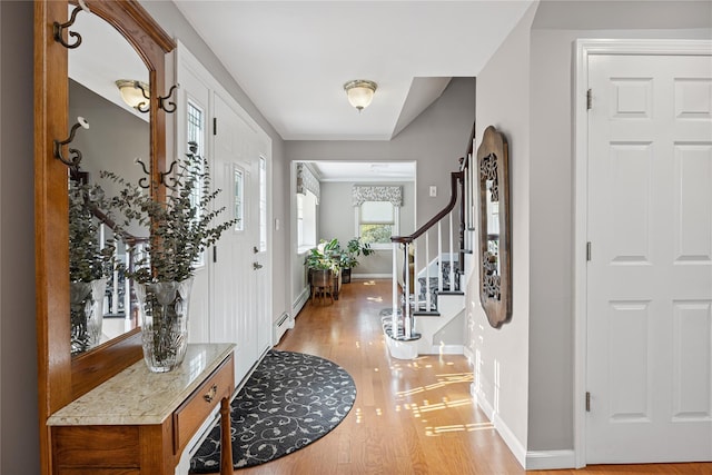 15 Shadetree Ln, Stony Brook, NY 11790 - entryway with light wood-style flooring, stairs, and baseboard heating