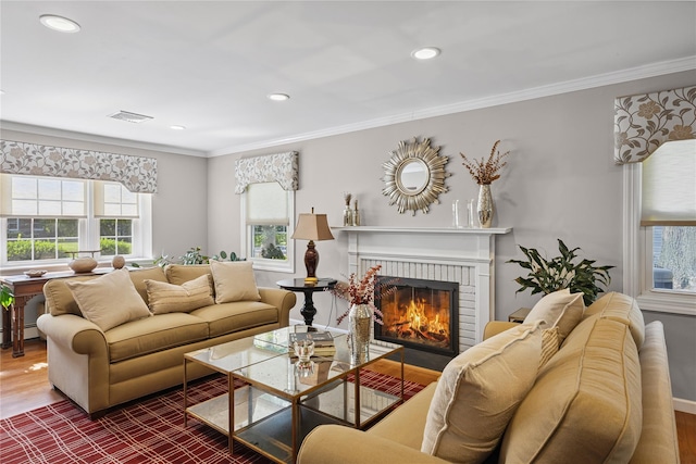 15 Shadetree Ln, Stony Brook, NY 11790 - living room featuring wood finished floors, a brick fireplace, recessed lighting, crown molding, and a baseboard radiator