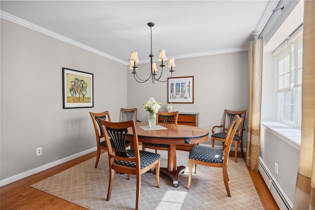 15 Shadetree Ln, Stony Brook, NY 11790 - dining space featuring a baseboard radiator, light wood finished floors, a chandelier, and crown molding