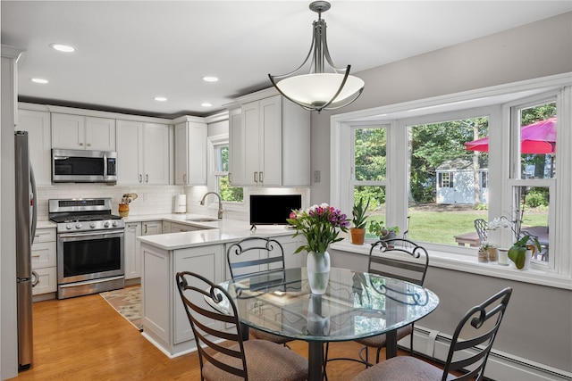 15 Shadetree Ln, Stony Brook, NY 11790 - kitchen with stainless steel appliances, plenty of natural light, backsplash, a peninsula, and recessed lighting