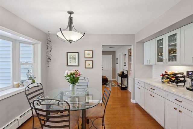 15 Shadetree Ln, Stony Brook, NY 11790 - dining room featuring a baseboard heating unit and wood finished floors