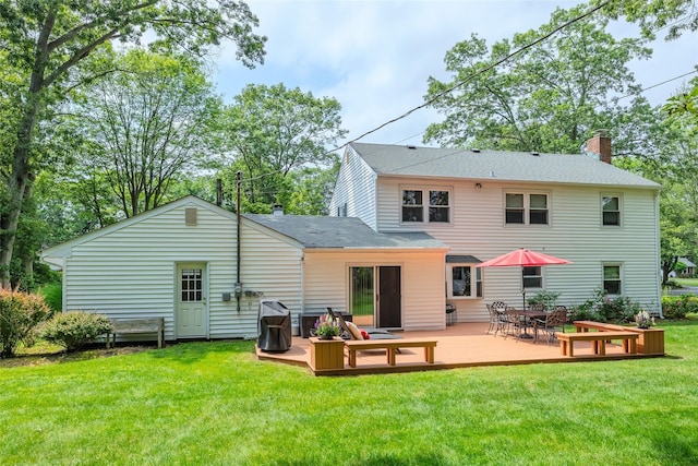 15 Shadetree Ln, Stony Brook, NY 11790 - back of property with a chimney, a wooden deck, a lawn, roof with shingles, and outdoor dining area
