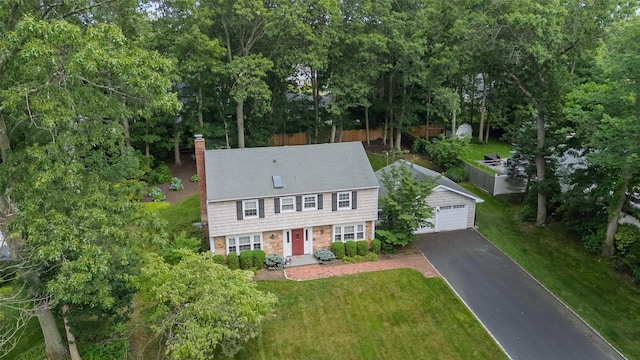 15 Shadetree Ln, Stony Brook, NY 11790 - colonial house with a chimney, a garage, an outdoor structure, and view of wooded area