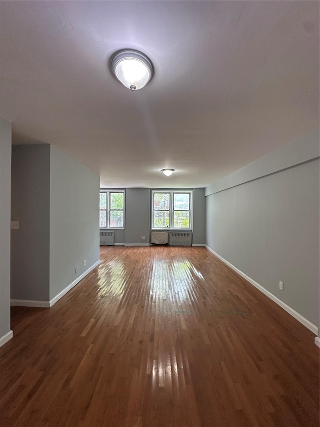 86-16 60th Ave Unit 1C, Elmhurst, NY 11373 - unfurnished room with wood-type flooring and a wall mounted air conditioner