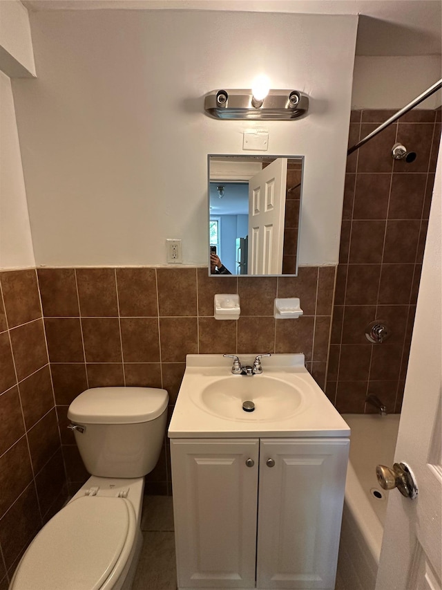 86-16 60th Ave Unit 1C, Elmhurst, NY 11373 - bathroom with tile walls, vanity, shower / bathtub combination, and wainscoting
