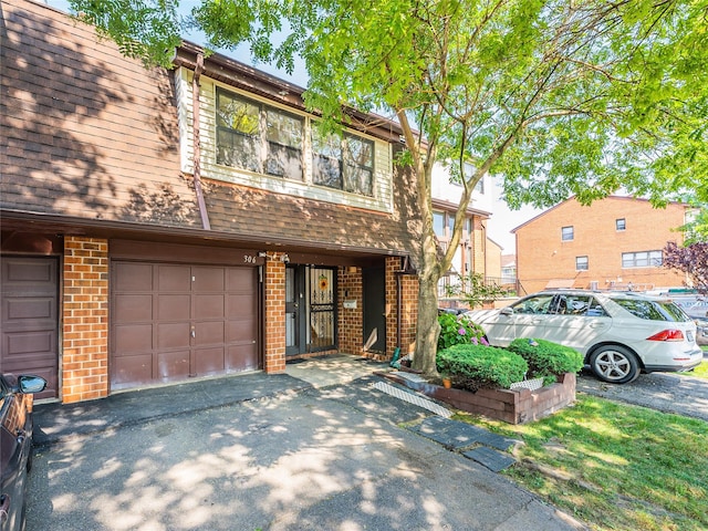 3-06 121st St, College Point, NY 11356 - townhome / multi-family property featuring brick siding, driveway, an attached garage, and a shingled roof