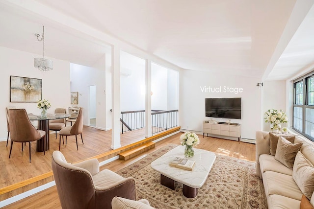 3-06 121st St, College Point, NY 11356 - living area featuring light wood finished floors and a chandelier