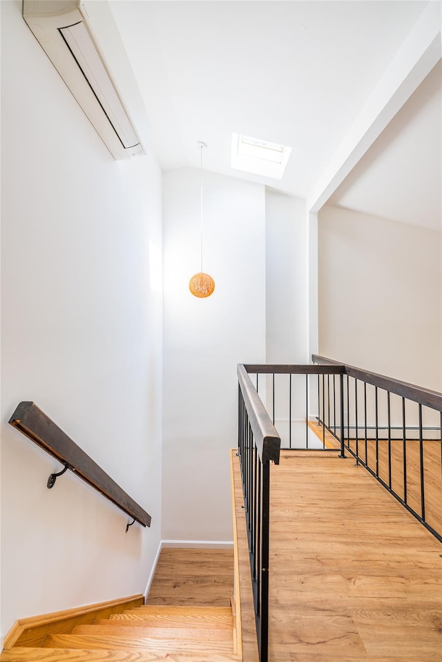 3-06 121st St, College Point, NY 11356 - stairway with an AC wall unit, wood finished floors, attic access, and vaulted ceiling