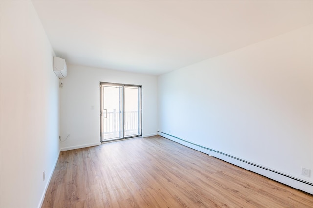 3-06 121st St, College Point, NY 11356 - empty room featuring baseboard heating, a wall mounted air conditioner, and light wood-style flooring