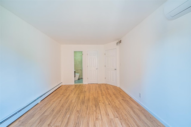 3-06 121st St, College Point, NY 11356 - spare room with a baseboard heating unit, a wall unit AC, and light wood-type flooring