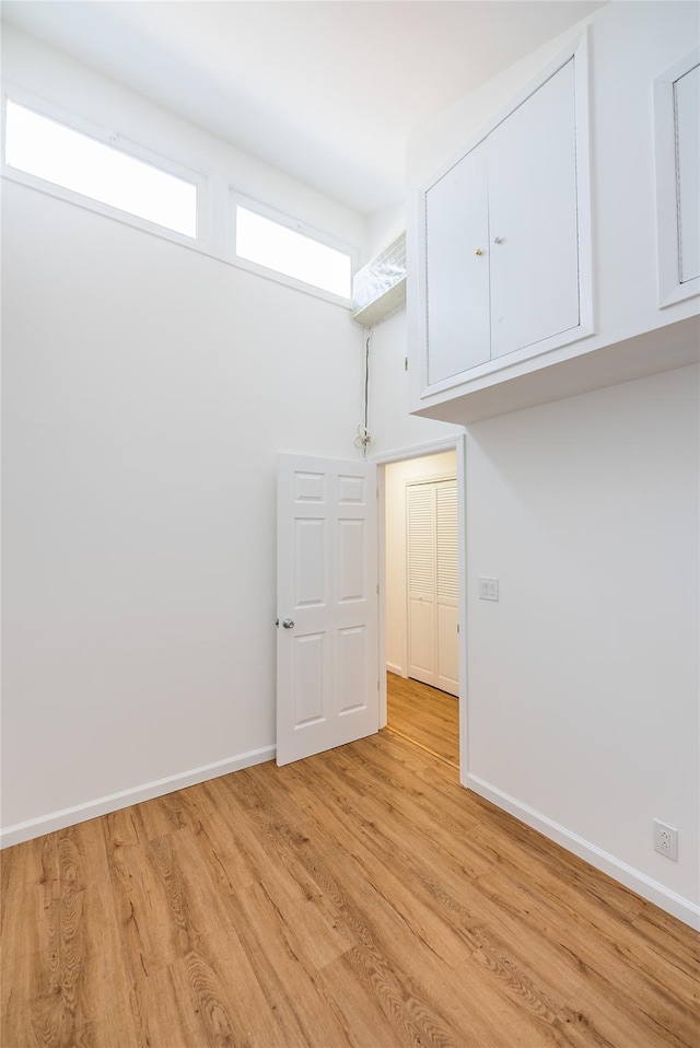 3-06 121st St, College Point, NY 11356 - laundry room featuring light wood-style floors and baseboards