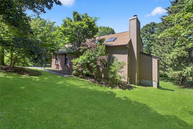 53 Mountain View Dr, Holmes, NY 12531 - rear view of house featuring a yard and a chimney