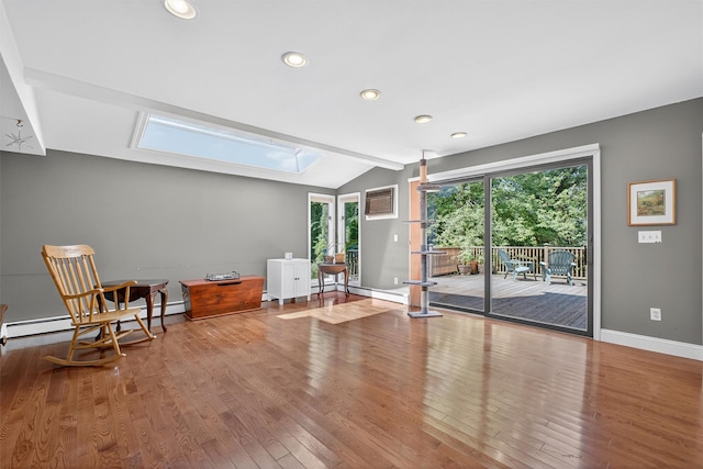 53 Mountain View Dr, Holmes, NY 12531 - sitting room with vaulted ceiling, a skylight, wood finished floors, a baseboard heating unit, and a wall mounted AC