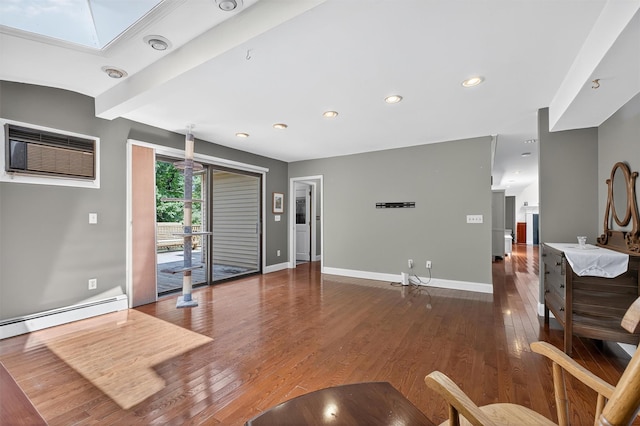 53 Mountain View Dr, Holmes, NY 12531 - living room featuring a skylight, a wall unit AC, wood finished floors, a baseboard heating unit, and recessed lighting