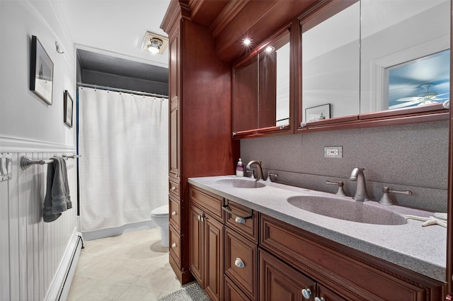53 Mountain View Dr, Holmes, NY 12531 - full bath with a baseboard radiator, double vanity, a ceiling fan, a shower with shower curtain, and decorative backsplash