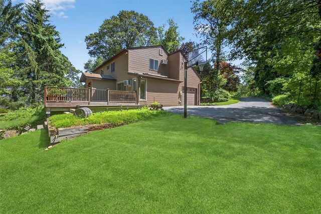 53 Mountain View Dr, Holmes, NY 12531 - rear view of property with a deck, a yard, driveway, and an attached garage