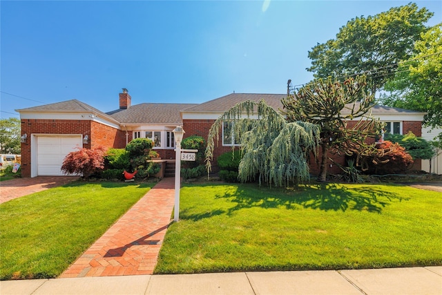 3458 Frederick St, Oceanside, NY 11572 - view of front of property with brick siding, an attached garage, and a front yard