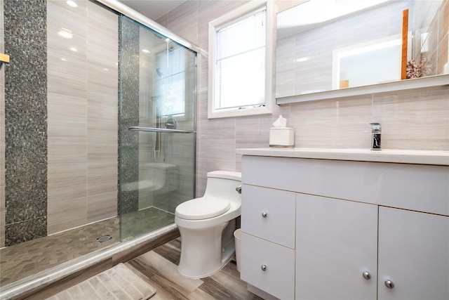 3458 Frederick St, Oceanside, NY 11572 - bathroom with vanity, a stall shower, tile walls, and wood finished floors