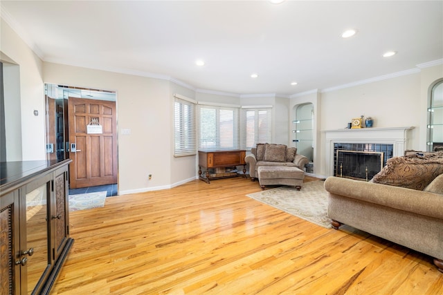 3458 Frederick St, Oceanside, NY 11572 - living room with light wood-style flooring, ornamental molding, a fireplace, recessed lighting, and arched walkways