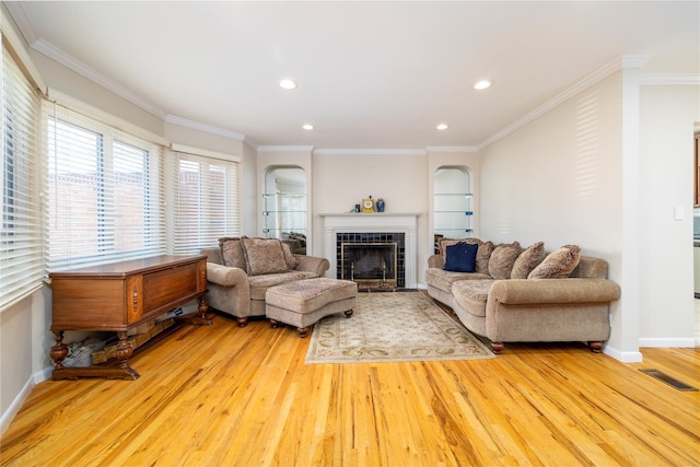 3458 Frederick St, Oceanside, NY 11572 - living area with wood finished floors, ornamental molding, arched walkways, a tile fireplace, and recessed lighting