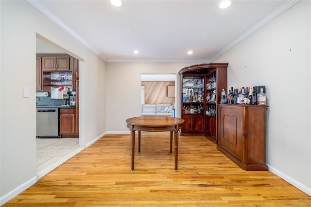 3458 Frederick St, Oceanside, NY 11572 - dining space featuring a dry bar, recessed lighting, light wood-type flooring, and ornamental molding