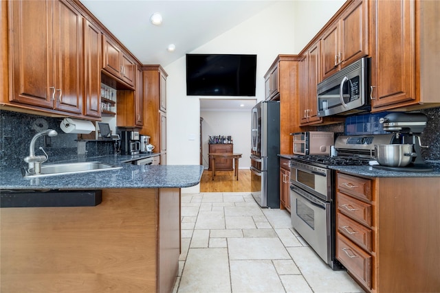 3458 Frederick St, Oceanside, NY 11572 - kitchen featuring stainless steel appliances, tasteful backsplash, stone tile flooring, dark stone counters, and brown cabinetry