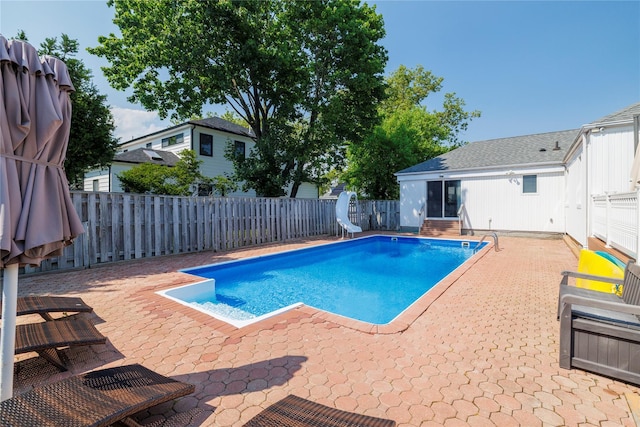 3458 Frederick St, Oceanside, NY 11572 - view of swimming pool with a water slide, a patio area, and a fenced backyard