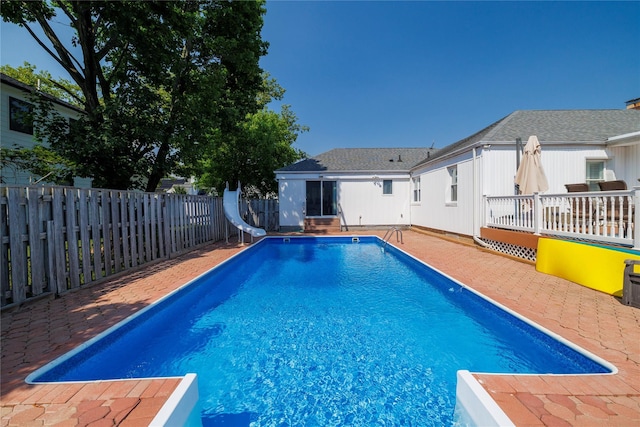 3458 Frederick St, Oceanside, NY 11572 - view of pool featuring a water slide, a fenced backyard, and a patio
