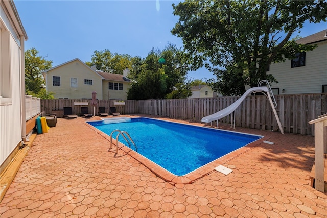 3458 Frederick St, Oceanside, NY 11572 - view of pool featuring a water slide, a patio, and a fenced backyard
