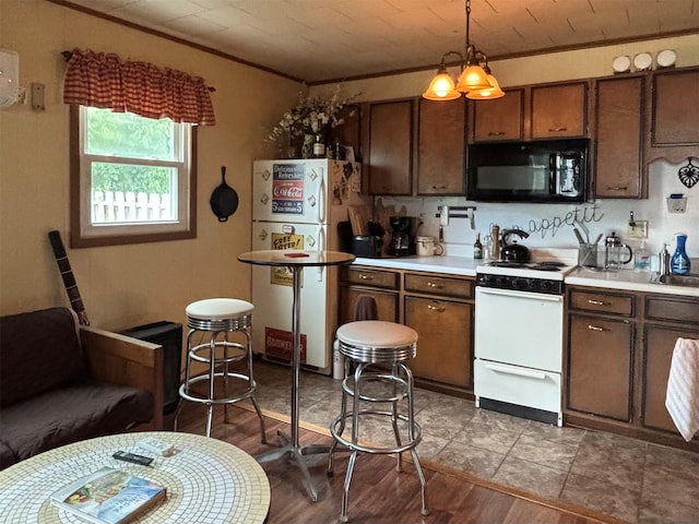 11 Berry St, Wallkill, NY 12589 - kitchen with white appliances, light countertops, wood finished floors, pendant lighting, and ornamental molding