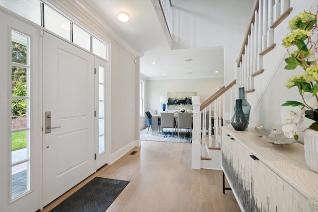 46 Plainview Rd, Woodbury, NY 11797 - entryway featuring ornamental molding, light wood finished floors, healthy amount of natural light, stairs, and recessed lighting