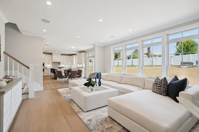 46 Plainview Rd, Woodbury, NY 11797 - living room with ornamental molding, light wood finished floors, stairs, and recessed lighting