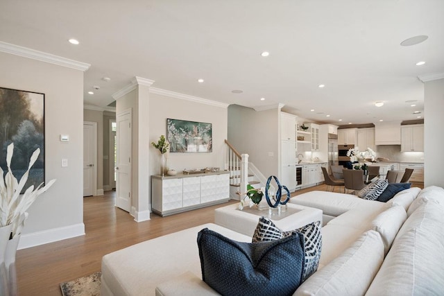46 Plainview Rd, Woodbury, NY 11797 - living area featuring beverage cooler, ornamental molding, recessed lighting, light wood-type flooring, and stairs